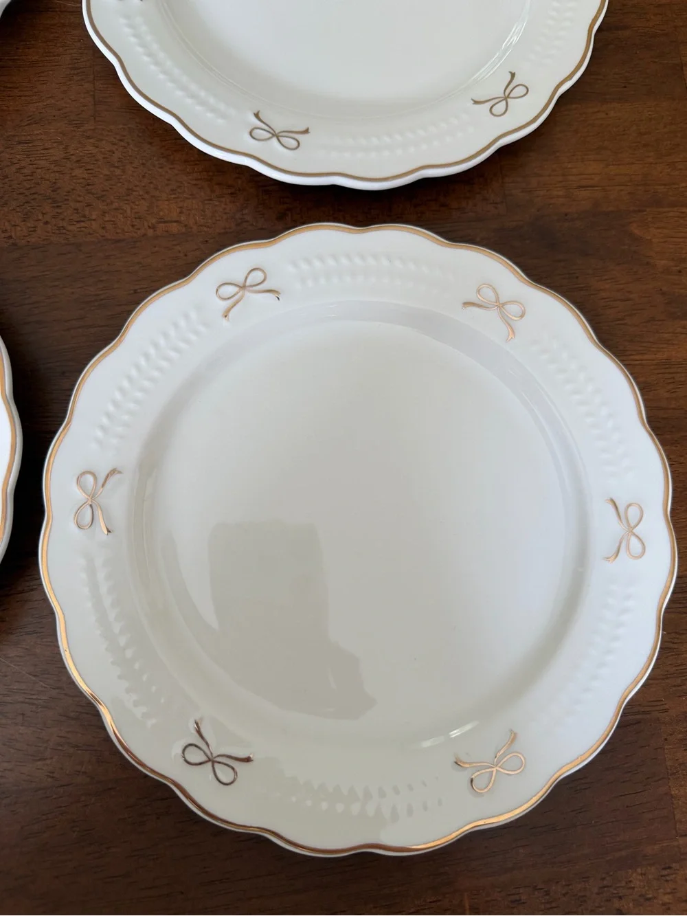 Set of White Scalloped Dinner Plates with Gold Bow Details